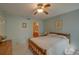 Bedroom with ensuite bathroom access, ceiling fan, and double bed at 1106 Lennox W Rd, Palm Harbor, FL 34683