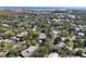 Aerial view of a community with houses and lush green trees at 1106 Lennox W Rd, Palm Harbor, FL 34683
