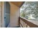 Private balcony overlooking backyard and trees at 1106 Lennox W Rd, Palm Harbor, FL 34683