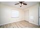 Bright bedroom with ceiling fan, laminate flooring, and ample closet space at 101 Lake Ne Ave # 211, Largo, FL 33771