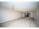 Spacious living room with light flooring and sliding doors to balcony at 101 Lake Ne Ave # 211, Largo, FL 33771