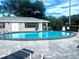Community pool with surrounding patio and lounge chairs at 101 Lake Ne Ave # 211, Largo, FL 33771
