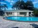 Community pool with patio and lounge chairs at 101 Lake Ne Ave # 211, Largo, FL 33771