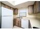 Kitchen with white appliances and wood cabinets at 101 Lake Ne Ave # 211, Largo, FL 33771