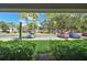 View from patio showcasing lush landscaping and parking at 36750 Us Highway 19 N # 09110, Palm Harbor, FL 34684