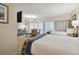 Bedroom with two beds, access to balcony, and a sofa at 36750 Us Highway 19 N # 09110, Palm Harbor, FL 34684