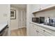 A microwave and additional white cabinets are shown in this kitchen at 36750 Us Highway 19 N # 09110, Palm Harbor, FL 34684