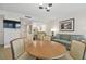 Dining area with a round table and chairs, adjacent to the living room at 36750 Us Highway 19 N # 09110, Palm Harbor, FL 34684