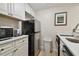 White cabinets, stainless steel appliances, and a microwave are featured in this galley kitchen at 36750 Us Highway 19 N # 09110, Palm Harbor, FL 34684