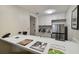 Compact kitchen featuring a breakfast bar and modern appliances at 36750 Us Highway 19 N # 09110, Palm Harbor, FL 34684