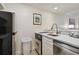 Small kitchen with black refrigerator, dishwasher, and sink at 36750 Us Highway 19 N # 09110, Palm Harbor, FL 34684