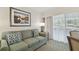 Living room with sofa and access to balcony at 36750 Us Highway 19 N # 09110, Palm Harbor, FL 34684