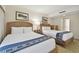Two twin beds with wooden headboards and blue accents at 36750 Us Highway 19 N # 09110, Palm Harbor, FL 34684