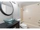 Clean bathroom with a bathtub and glass sink at 14323 Hanging Moss Cir # 102, Tampa, FL 33613