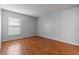 Well-lit bedroom with hardwood floors and window at 14323 Hanging Moss Cir # 102, Tampa, FL 33613