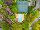 Aerial view of community pool, tennis courts, and residential buildings at 14323 Hanging Moss Cir # 102, Tampa, FL 33613