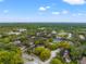 Aerial view of community with tennis courts and lush landscaping at 14323 Hanging Moss Cir # 102, Tampa, FL 33613