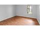 Simple bedroom with hardwood floors and a window at 14323 Hanging Moss Cir # 102, Tampa, FL 33613