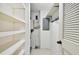 White storage shelves and closet with electrical panel at 36750 Us Highway 19 N # 04208, Palm Harbor, FL 34684