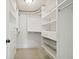 Bright walk-in closet with built-in shelves and drawers at 36750 Us Highway 19 N # 04208, Palm Harbor, FL 34684