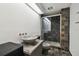 Bathroom with granite sink, dark tile shower, and toilet at 36750 Us Highway 19 N # 04208, Palm Harbor, FL 34684