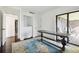 Room with dark wood table, rug, and access to balcony and bath at 36750 Us Highway 19 N # 04208, Palm Harbor, FL 34684