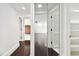 Bright hallway with dark hardwood floors and mirrored closet doors at 36750 Us Highway 19 N # 04208, Palm Harbor, FL 34684