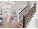 Bright entryway with hardwood floors and staircase with metal railing at 913 Buckhurst Dr, Spring Hill, FL 34609