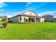 Well-maintained house exterior, lush green lawn, and backyard at 913 Buckhurst Dr, Spring Hill, FL 34609