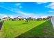 Large backyard with green grass, playground, and privacy fence at 913 Buckhurst Dr, Spring Hill, FL 34609