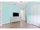Light blue bedroom with a dresser and large closet at 913 Buckhurst Dr, Spring Hill, FL 34609