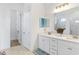 Double vanity bathroom with white cabinets and walk-in shower at 913 Buckhurst Dr, Spring Hill, FL 34609