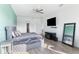 Main bedroom with round tufted bed and light green accent wall at 913 Buckhurst Dr, Spring Hill, FL 34609