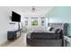 Spacious main bedroom with round bed, TV, and accent wall at 913 Buckhurst Dr, Spring Hill, FL 34609