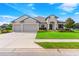 Two-story house with three-car garage, manicured lawn, and mature trees at 913 Buckhurst Dr, Spring Hill, FL 34609