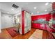 Modern red kitchen with stainless steel appliances and hardwood floors at 1 Beach Se Dr # 2007, St Petersburg, FL 33701