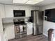 Stainless steel appliances and white shaker cabinets in this galley kitchen at 1100 E Bay Dr # 42, Largo, FL 33770