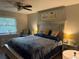 Main bedroom with king-size bed, ceiling fan, and dresser at 1100 E Bay Dr # 42, Largo, FL 33770