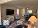 Bright living room features comfy seating, large TV, and wood-look floors at 1100 E Bay Dr # 42, Largo, FL 33770