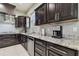 Modern kitchen with dark wood cabinets and granite countertops at 3910 Oldbrook Ln, Plant City, FL 33566