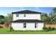 Two-story home showcasing the backyard and landscaping at 12905 Worchester Ave, Tampa, FL 33624