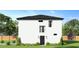 Side view of the two-story house and landscaping at 12905 Worchester Ave, Tampa, FL 33624