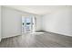 Bedroom with wood-look floors and access to a deck overlooking the water at 3825 Pompano Se Dr, St Petersburg, FL 33705
