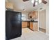 Kitchen with wood cabinets, black appliances, and a breakfast nook at 3825 Pompano Se Dr, St Petersburg, FL 33705