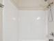 White tiled shower with handheld shower head at 3825 Pompano Se Dr, St Petersburg, FL 33705