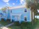 Light blue two-story home with white trim and walkway at 3825 Pompano Se Dr, St Petersburg, FL 33705