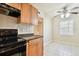 Kitchen with wood cabinets, black appliances, and a breakfast nook at 3825 Pompano Se Dr, St Petersburg, FL 33705