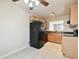 Kitchen with wood cabinets, black appliances, and a breakfast nook at 3825 Pompano Se Dr, St Petersburg, FL 33705