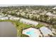 Aerial view showing a community pool and surrounding buildings near the water at 3825 Pompano Se Dr, St Petersburg, FL 33705