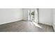 Bright bedroom featuring wood-look floors and private balcony access at 3825 Pompano Se Dr, St Petersburg, FL 33705